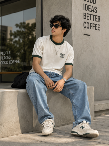 Young man wearing a vintage-inspired Ringer Tee with baggy jeans and sneakers COTTRIXS